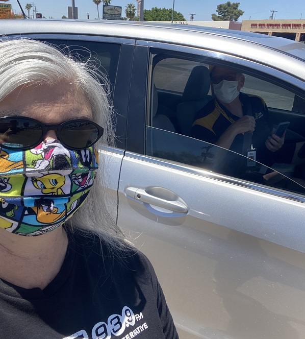 A lady Wear a mask with picture designs and a cooling glass